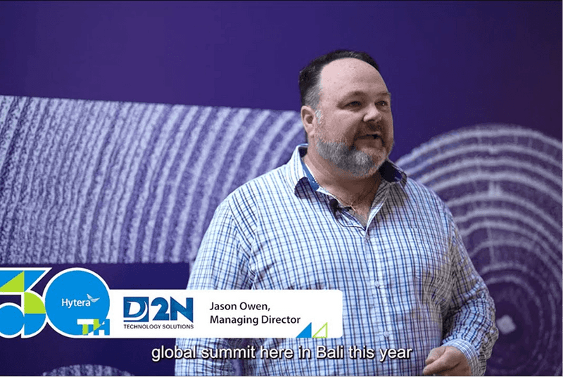 Man standing in front of a branded backdrop with 'D2N' and 'Hytera' logos.